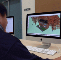 Student looks at computer with images on it