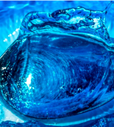 blue image of spoon in water, vivid blues cover and surround the spoon